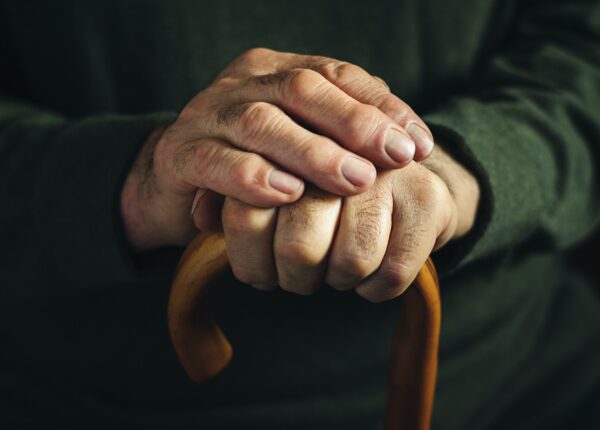 Gnarled arthritic fingers of an old man